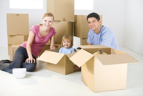 Removal company team preparing a moving van with packed boxes