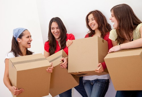 Professional movers carefully packing fragile belongings in Colliers Wood