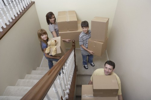 Packed moving boxes and furniture ready for collection in Colliers Wood